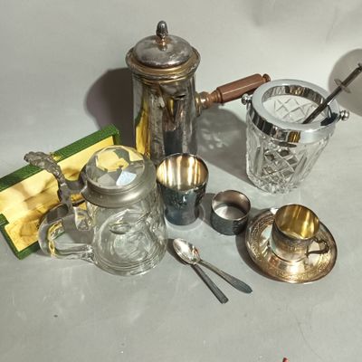 a lot of silver and glass items sitting on a table