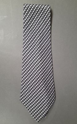 black and white checkered necktie on a gray background