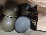 many helmets in a brown paper bag on the floor
