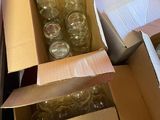 many boxes of empty glass jars in the middle of the floor