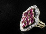 a close up of a pink and white diamond ring on a black surface