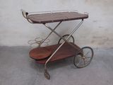 a small wooden cart with a metal handle on it