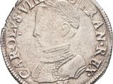 a silver coin with a portrait of a man on it