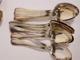 five spoons that are sitting next to each other on a table
