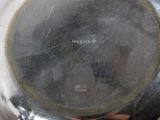 a silver plate that has a picture of a person on it