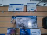 boxes of brother products are on display in a store