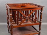 an old wooden table with a magazine rack on top of it
