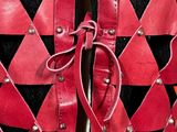 red and black leather vest with metal studs on a mannequin mannequin mannequin mannequin mannequin mannequin mannequin