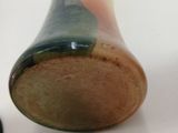 a close up of a small vase on a table