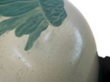 a large white vase with a green design on it