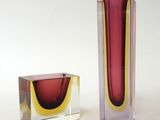 two vases sitting next to each other on a table