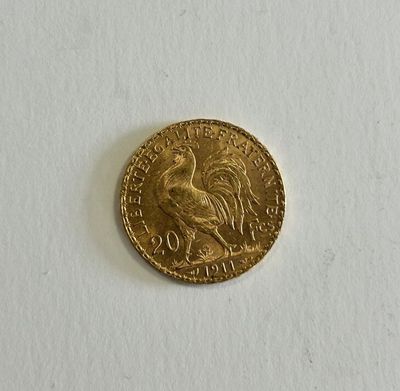 a close up of a gold coin on a white surface
