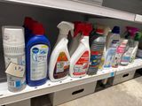 many bottles of cleaning products on a shelf in a store