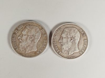 two silver coins, one of which has a man ' s face and the other of which is a woman