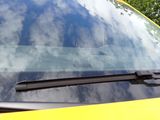 a yellow car that is parked on the side of the road