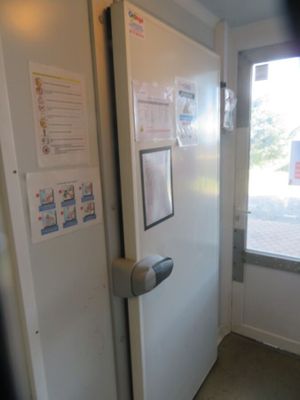a white refrigerator in the corner of a room