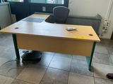 a desk with a chair and a computer on it