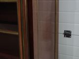 a bathroom with a toilet and a cabinet in it