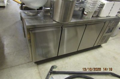 stainless steel counter top with pots and pans on it in a commercial kitchen