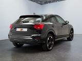 the rear end of a grey audi suv parked in a garage
