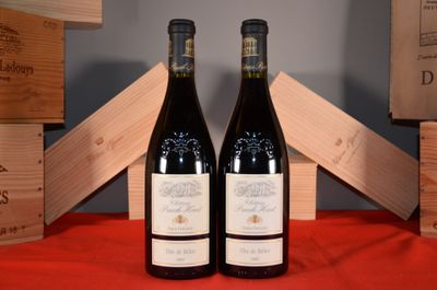 two bottles of wine sitting next to each other on a table