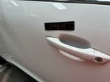 a car door handle with a sticker on it