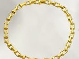an image of a gold bracelet on a white background