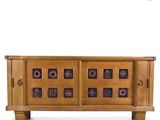 a wooden sideboard with a floral design on the front