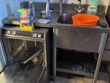 a kitchen with a sink and a dishwasher in it
