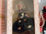 a box with a doll in it and a doll in it