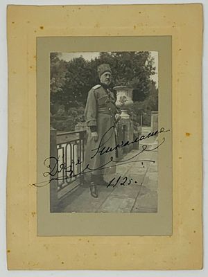 an old black and white photo of a man standing on a bridge
