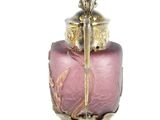 a pink glass vase with a gold handle on a white background