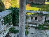 a stone pillar in the middle of a garden
