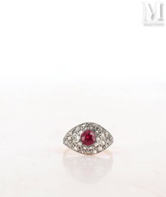 a close up of a diamond and ruby ring on a white surface