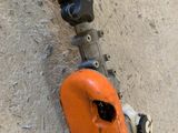 a chainsaw attached to the side of a concrete wall
