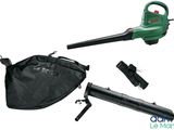 the green leaf blower is sitting next to a black bag