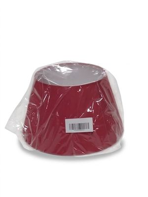 a red hat that is wrapped in plastic on a white background
