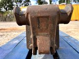 a metal object that is sitting on a wooden bench