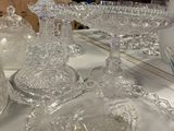 a lot of glass dishes and bowls on the table