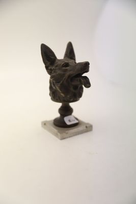 a statue of a dog that is sitting on a table