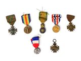 an assortment of medals and medals are displayed on a white surface