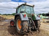 a tractor that is parked in the dirt