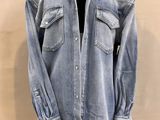 denim shirt on a mannequin stand on a white background