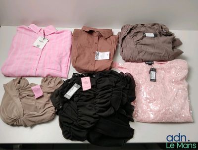 a lot of clothes that are sitting on a table