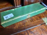 a green case sitting on top of a wooden table