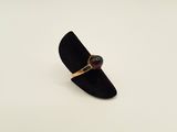 an image of a black ring with a red stone on it