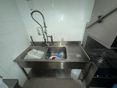 a kitchen with a sink and a stove in it
