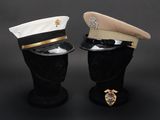 two hats are sitting on top of a mannequin head