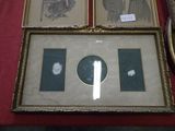two framed pictures of a man and a woman on a red table