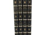 a set of four black books sitting on top of each other